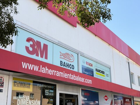 Palma, spain, august 2, 2026, hardware store facade with brand logos including 3m, bahco, bosch, and karcher, showing retail and industrial supply