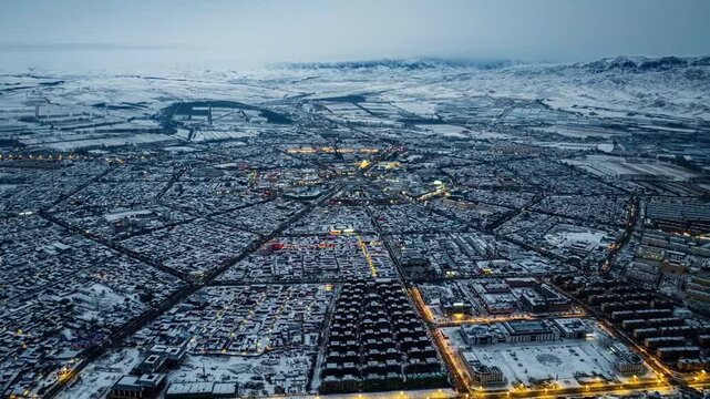 Snow Covered Ulaanbaatar Cityscape with Mountains at Twilight in Ulaanbaatar, Mongolia