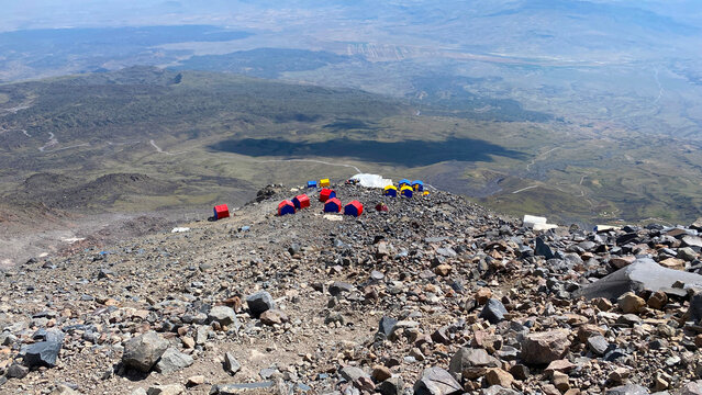 Tents sheltering expedition camp in elevated view on Mount Ararat, Turkey, showing temporary accommodation on volcanic terrain