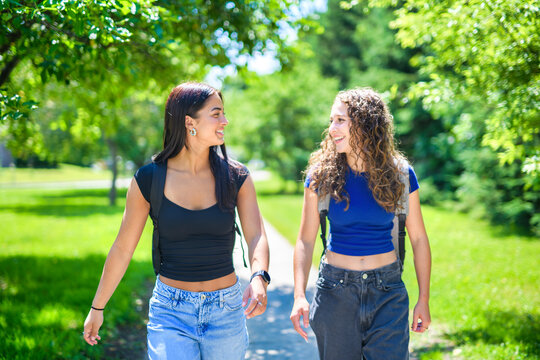 portrait of two teens friends students in university background
