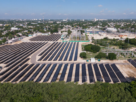Aerial view of the CFE Merida Area solar farm featuring rows of photovoltaic panels and electrical infrastructure in Merida, Yucatan, Mexico.
