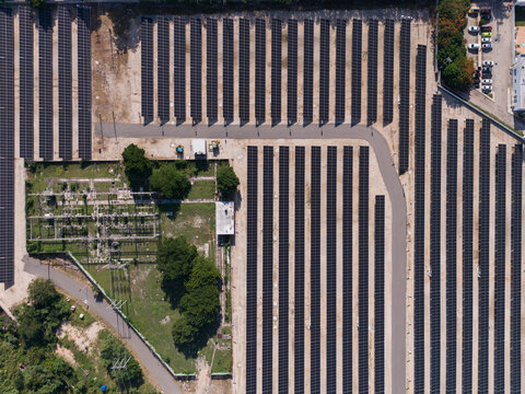 Aerial view of the CFE Merida Area solar farm featuring rows of photovoltaic panels, electrical infrastructure, and surrounding greenery in Merida, Yucatan, Mexico.
