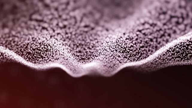 A close-up of a textured surface illuminated by soft diffused light, featuring intricate wavy patterns in deep purple with subtle gradients