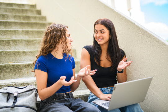 portrait of two teens friends students in university background