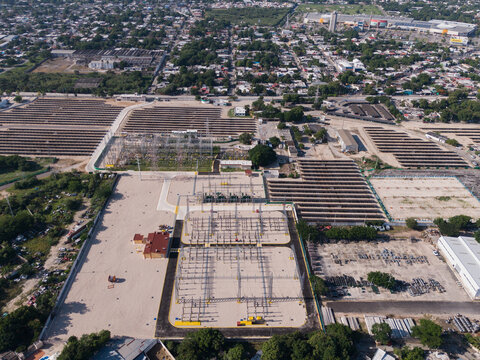 Aerial view of the CFE Merida Area electrical substation featuring power transformers and distribution infrastructure surrounded by urban rooftops and greenery in Merida, Yucatan, Mexico.