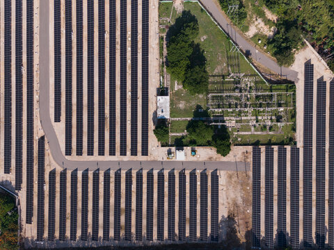 Aerial view of CFE Merida Area solar farm with rows of photovoltaic panels and electrical infrastructure in Merida, Yucatan, Mexico.