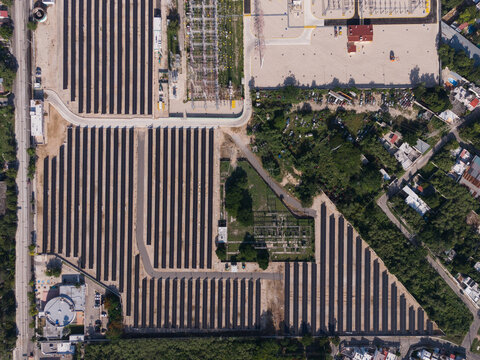 Aerial view of the CFE Merida Area solar power facility featuring rows of solar panels, electrical infrastructure, and surrounding vegetation in Merida, Yucatan, Mexico.
