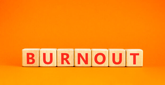 Burnout word symbol. Concept word Burnout on beautiful wooden blocks. Beautiful orange table orange background. Business medical burnout word concept. Copy space.
