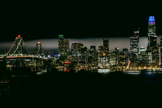 San Francisco Skyline at Night with Bay Bridge and City Lights Under Fog, Editorial Cityscape