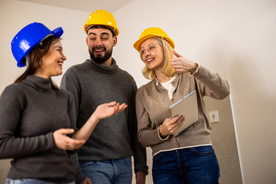 Construction team discussing a renovation project with a tablet