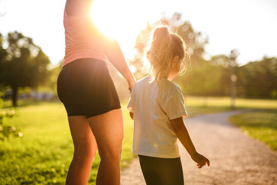 mother and daughter jog together on summer season