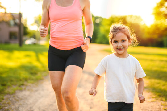 mother and daughter jog together on summer season