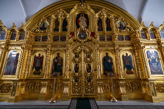 View of the ornate gilded iconostasis with religious icons and intricate wood carvings inside a church at the Solovetsky Islands in Solovetsky, Arkhangelsk Oblast, Russia.