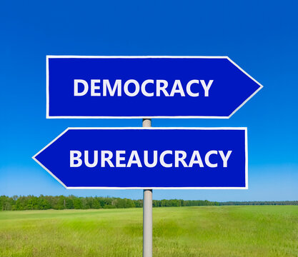 Democracy or bureaucracy words symbol. Concept words Democracy Bureaucracy on beautiful blue road sign. Beautiful blue sky background. Business democracy bureaucracy concept. Copy space