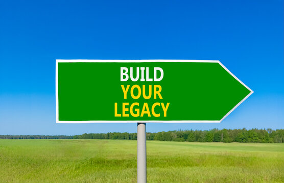 Build your legacy words symbol. Concept words Build your legacy on beautiful green road sign. Beautiful blue sky green grass background. Business build your legacy concept. Copy space.
