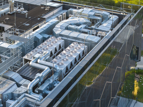 Aerial view of the AI data center cooling system with industrial fans and metal ductwork on a modern rooftop in Krakow, Lesser Poland Voivode, Poland.