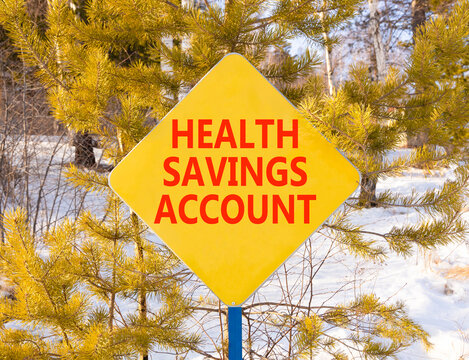 Health saving account symbol. Concept words Health saving account on beautiful yellow road sign. Beautiful winter forest background. Medical Health saving account concept. Copy space.