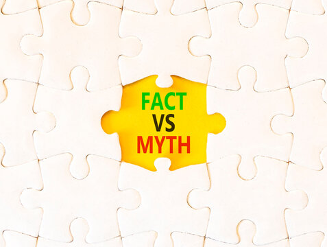 Fact vs versus myth words symbol. Concept words Fact vs Myth on beautiful white puzzle. Beautiful yellow background. Business and fact vs versus myth concept. Copy space.