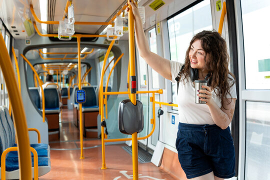 Woman with vitiligo commuting on murcia tram, traveling in an urban transport