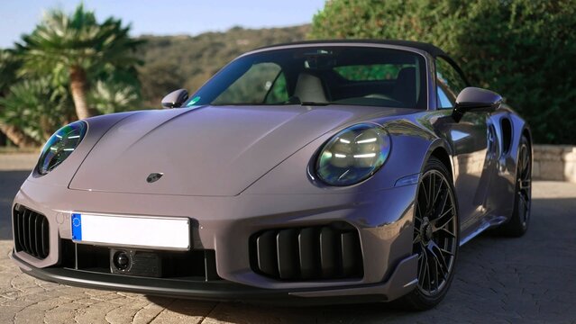 2026 Porsche 911 Turbo S Cabriolet, luxury sports car blue sports car on the road