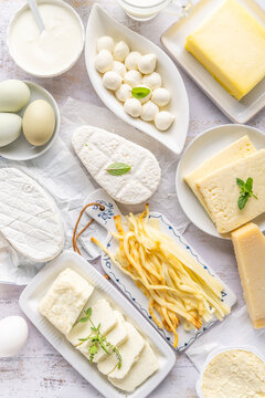 Assortment of dairy products including various cheeses, milk, and butter
