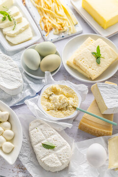 Assortment of dairy products including various cheeses, milk, and butter