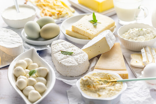 Assortment of dairy products including various cheeses, milk, and butter