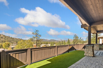 Naklejka premium Balcony view with wooden railing and blue sky