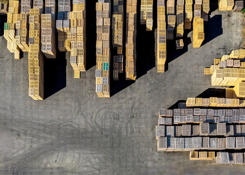 Aerial view of Foresco Middenmeer wooden pallets stacked in organized rows on a paved yard in Middenmeer, Noord-Holland, Netherlands.