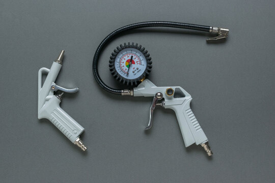 Automotive Air Compressor Tools with Pressure Gauge on Gray Background