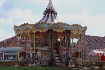 Colorful carousel with horses spinning at an amusement park © Natallia