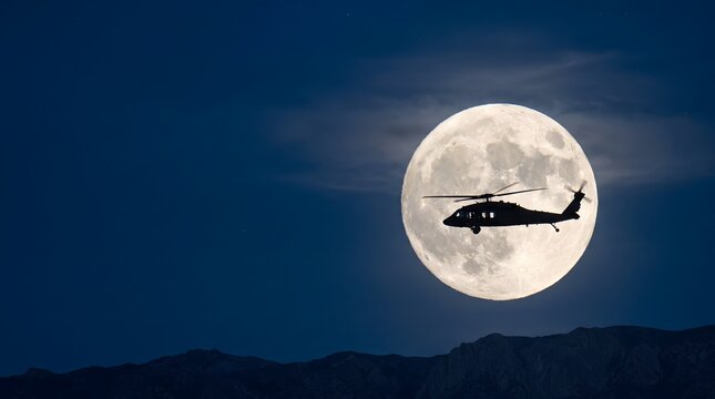 Silhouette of a military helicopter flying in front of a large full moon at night with night sky silhouette aircraft dark night moonlight