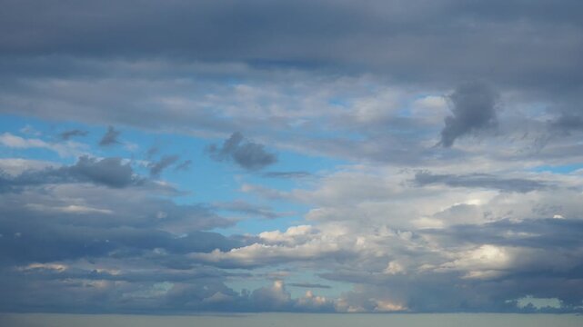 Clouds move during the afternoon. The sky shows a mix of blue and gray hues. Light changes