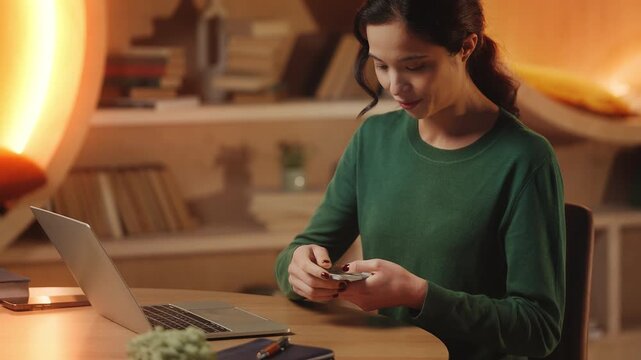 Asian woman counts money after successful online project, freelance income
