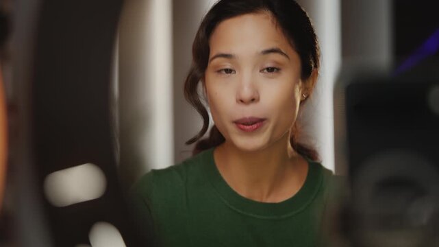 Young Korean female influencer records financial blog for social media on phone