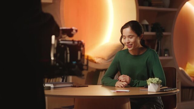 Cameraman films commercial video of Asian woman recording a lifestyle blog