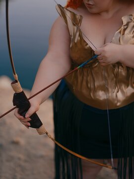Woman Hands Pulling Bowstring With Arrow Close Up