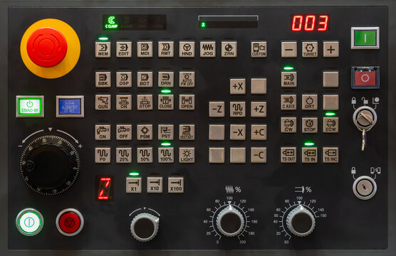 CNC machine control panel with emergency stop button, digital display, control keys, axis controls, rotary switches and industrial automation interface