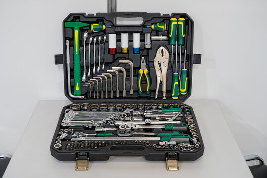 Complete mechanics tool set in open plastic case with ratchet handles, sockets, wrenches, screwdrivers, and pliers
