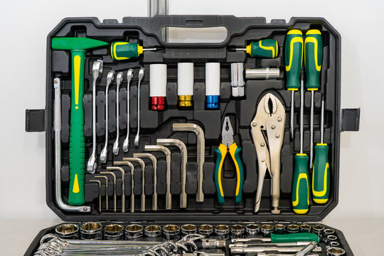 Professional tool kit with socket set, wrenches, screwdrivers, pliers and hex keys arranged in a protective case for mechanical repair and maintenance