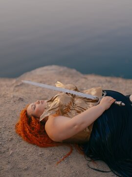 Plus Size Redhead Warrior Woman Lying Down Holding Sword