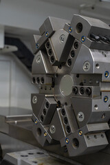 CNC lathe tool turret with numbered stations close-up, precision metalworking machinery, manufacturing equipment detail © Viktor Brazhnikow