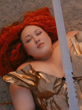 Plus Size Redhead Warrior Woman Lying Down Looking At Camera