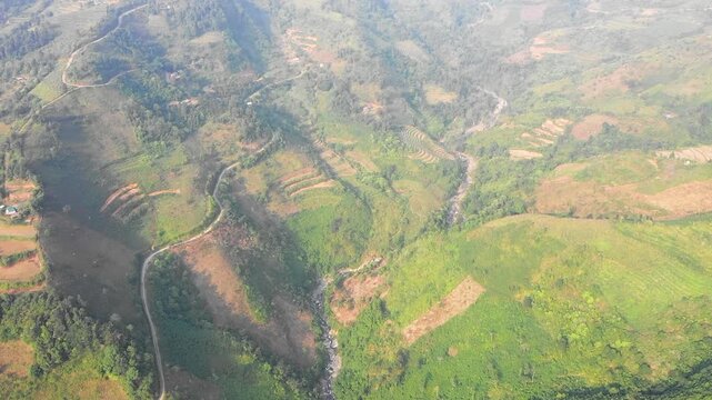 Aerial footage showcasing the lush, mountainous terrain around Bac Ha in Lao Cai Province, northern Vietnam. No people are visible in the scene.