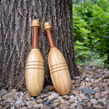 pair of Indian exercise clubs in backyard or park - functional fitness concept, clubs are particularly valuable for grip strength, shoulder work, and rotational core power
