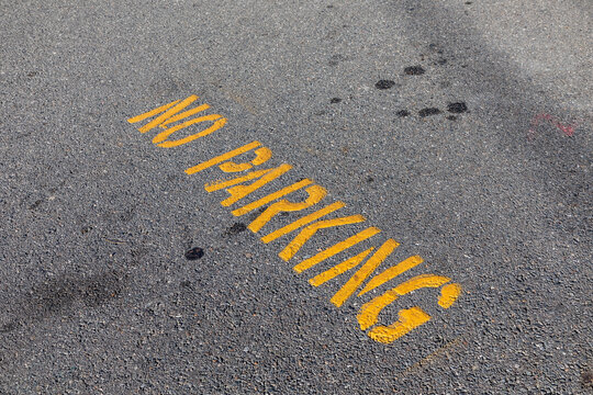no parking signage in yellow painted at the street