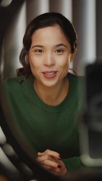 Friendly Korean woman records lifestyle blog on phone, social media content
