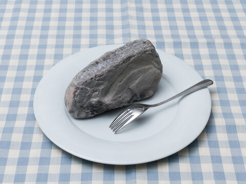 Rock on Plate Metaphor for Digestion Problems and Heavy Meal