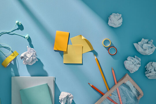 A vibrant, top view of a workspace arrangement with crumpled paper