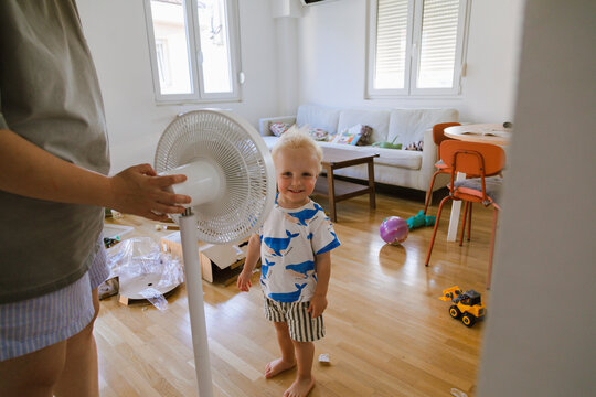 A woman and her child assemble a fan